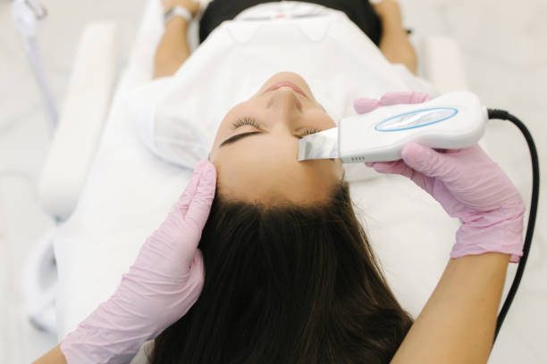 First-person view of cosmetologist doing beauty procedure at cosmetology clinic.